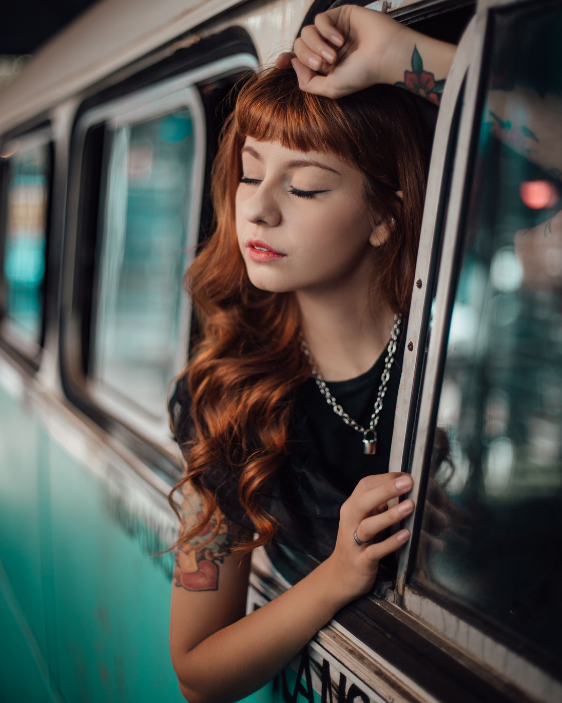 A Woman in Black Shirt Wearing Silver Necklace