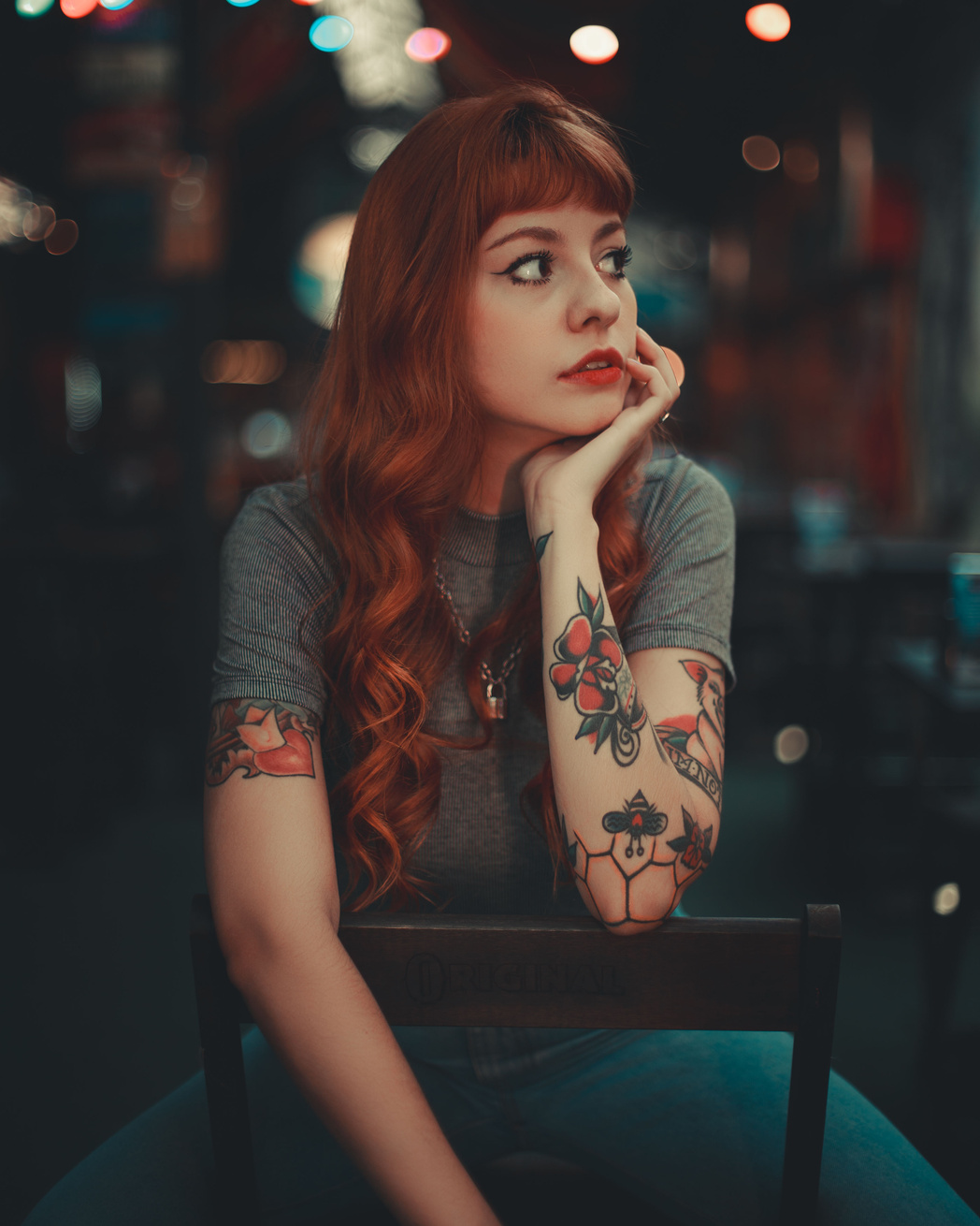 Photo of Woman in Gray Shirt Sitting on a Chair